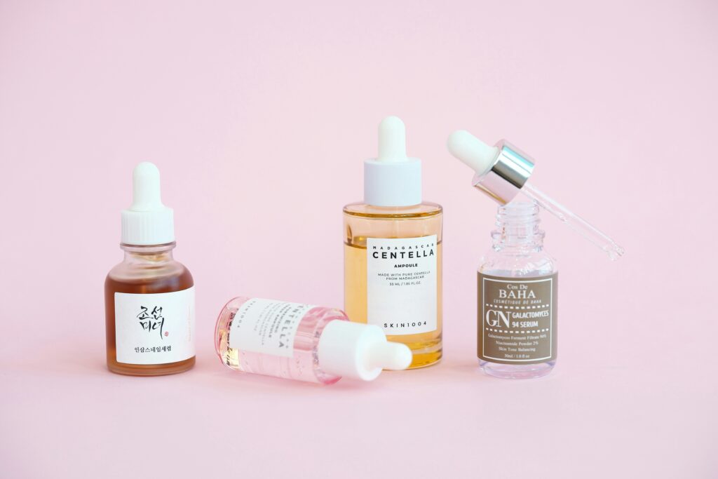 Photo showing various types of K-beauty essence and serum products laid out