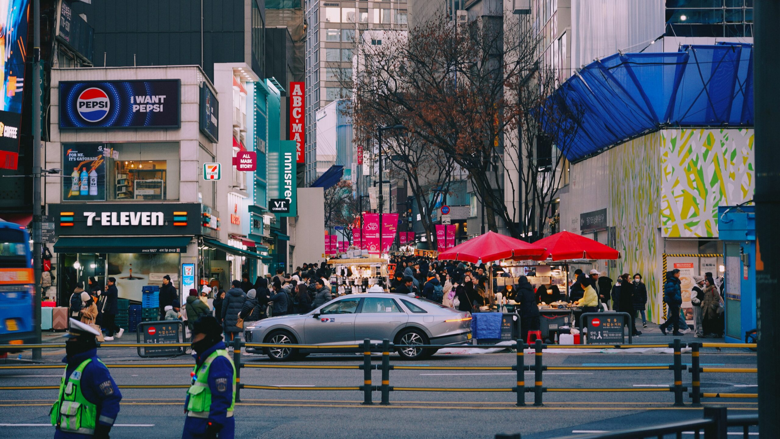 Night view of Myeongdong shopping street — brightly lit shops with many people