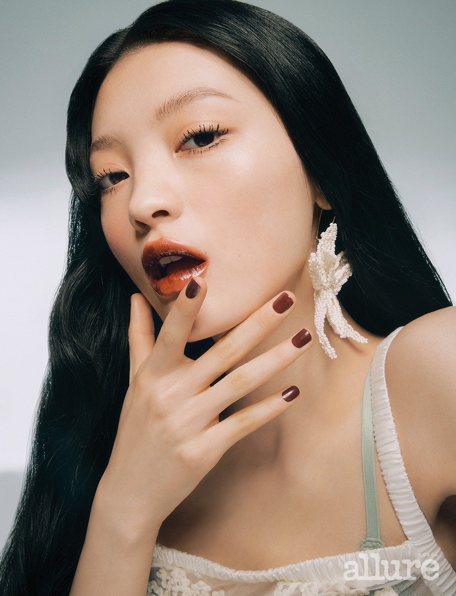 A professional makeup finished look with glossy berry-colored lips and dimensional eye makeup