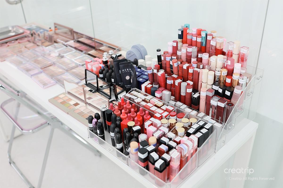 Hundreds of lipsticks and color products displayed in a personal color analysis studio.
