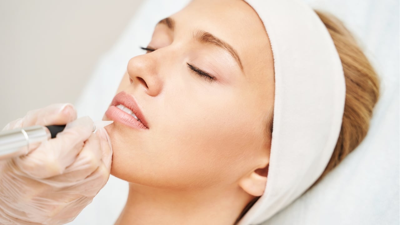 A scene from a South Korean dermatologist procedure in which pigments are injected into the lips using a fine instrument