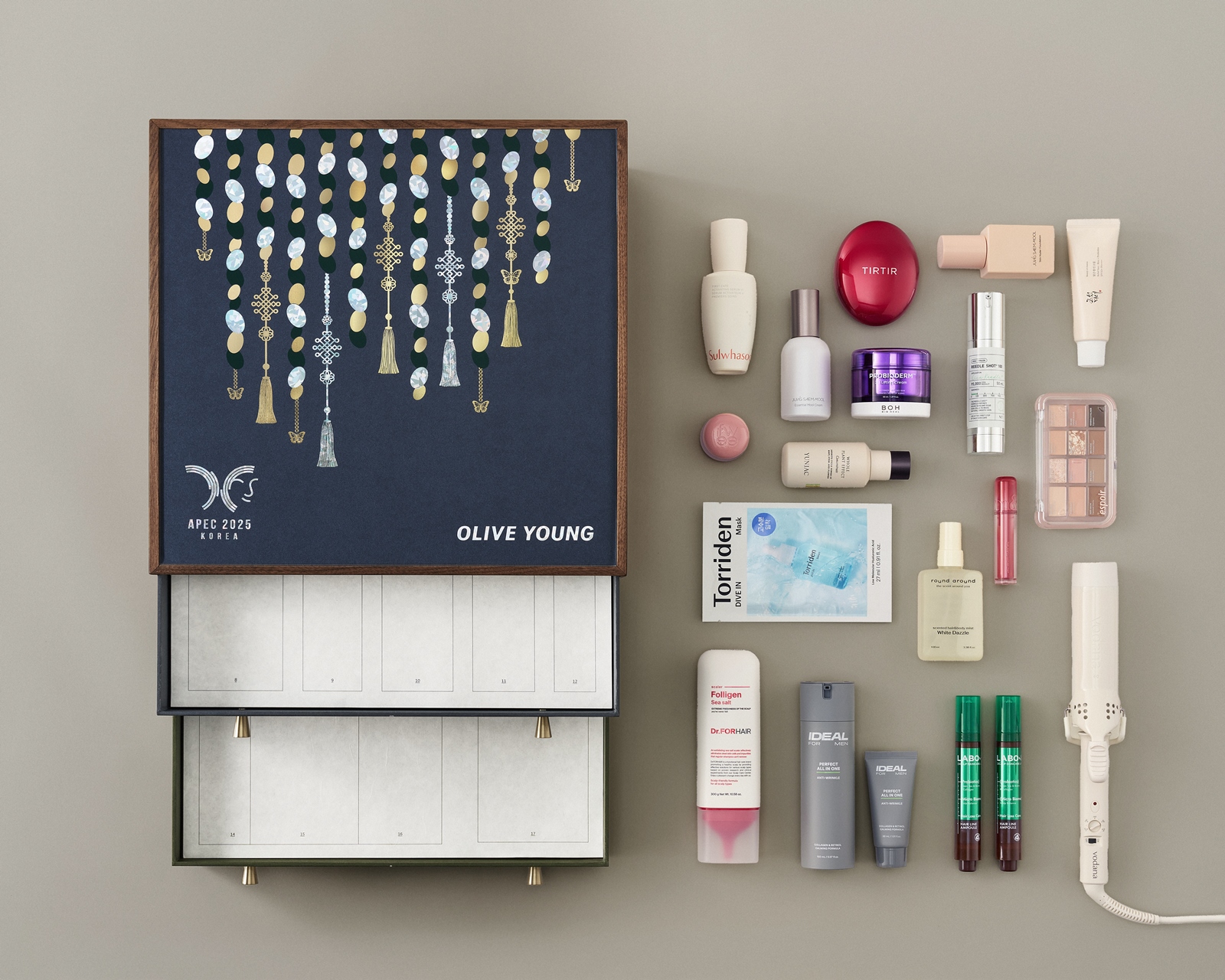 A glimpse of individual products arranged alongside the sophisticated box packaging of the Olive Young APEC package