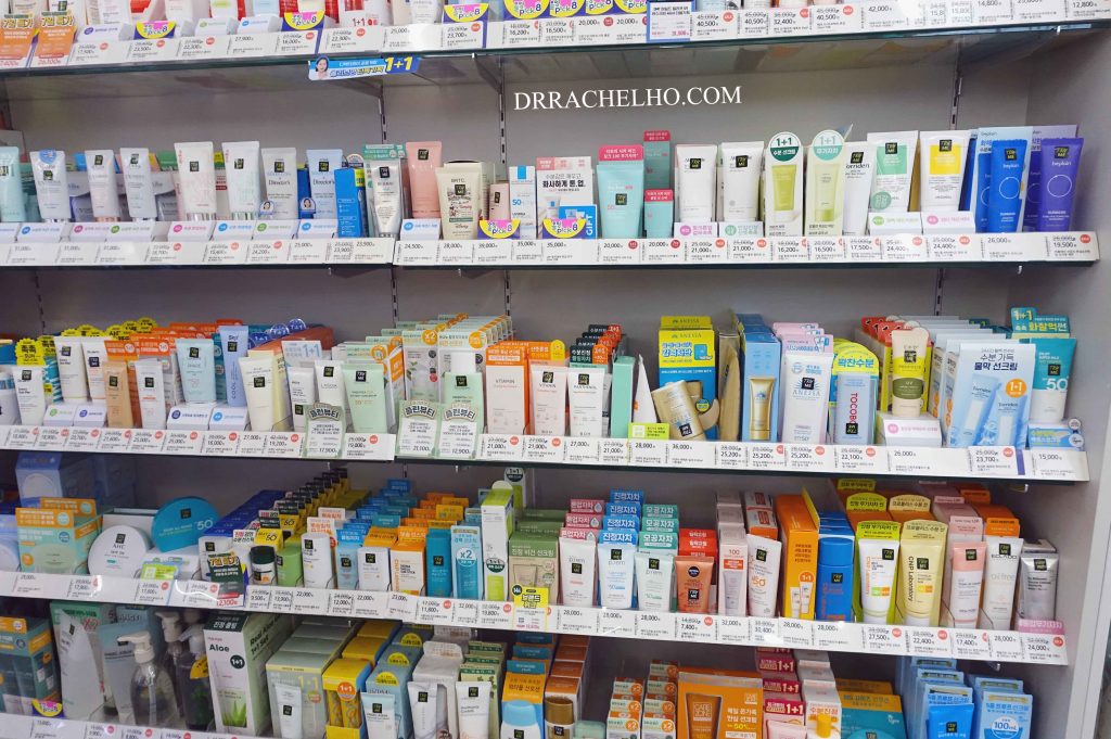 Various products from the Olive Young sunscreen section displayed on the shelves