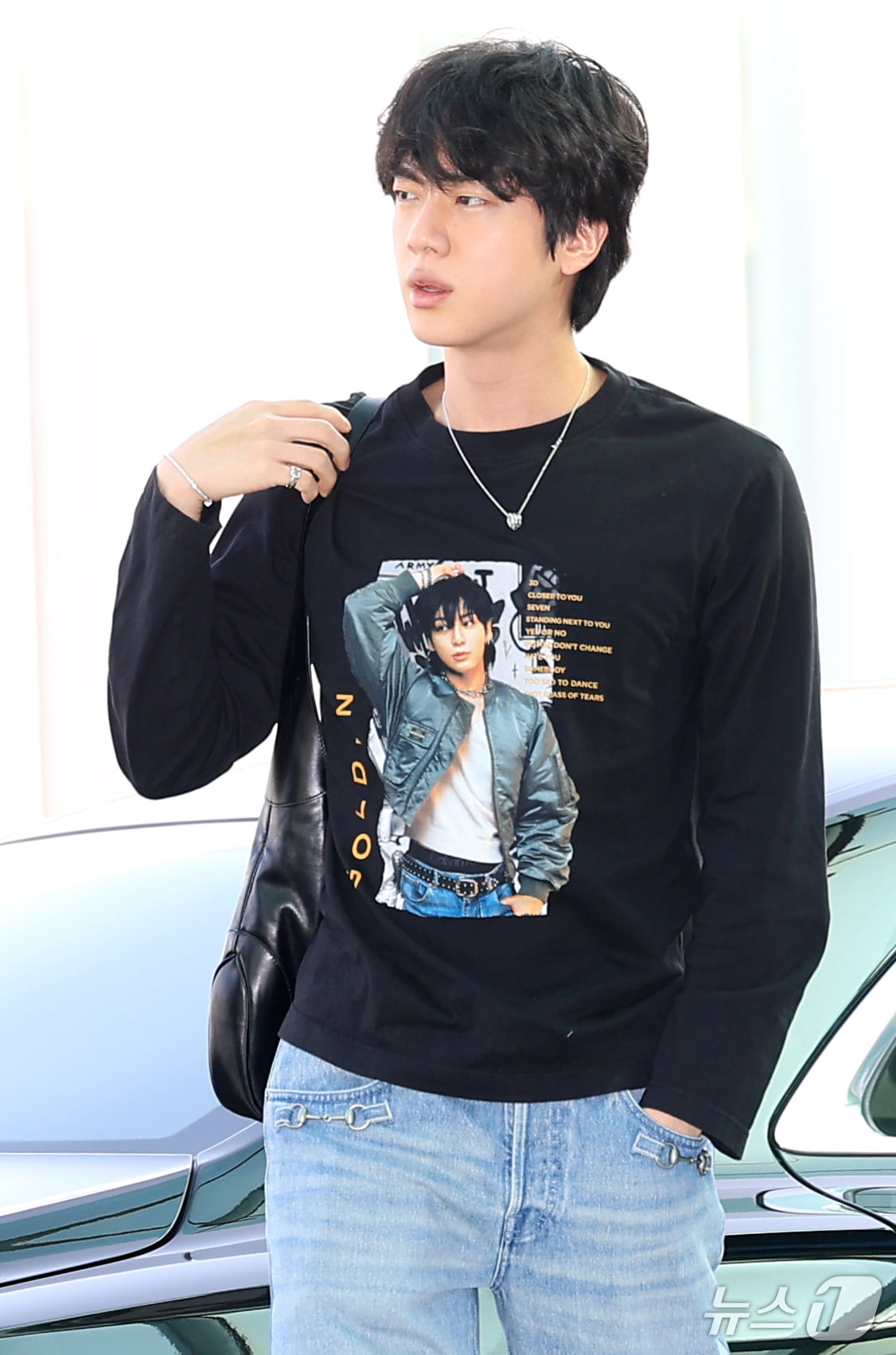 BTS's eldest member Jin wearing a T-shirt featuring Jungkook merchandise