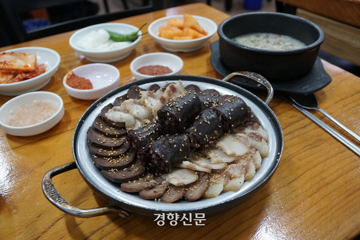 Hand-cut noodle soup and napa cabbage pancake at Andongjip, located in the basement of the new building of Gyeongdong Market