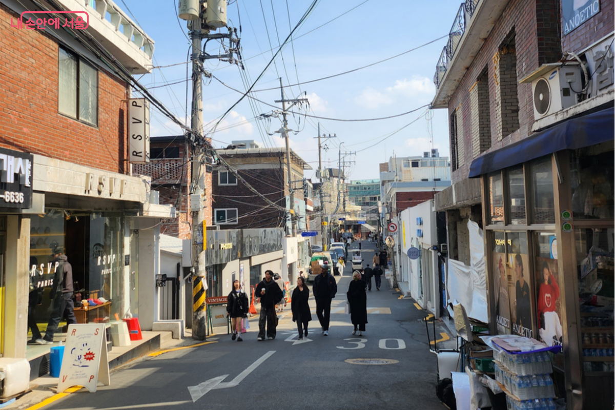 A view of small shops clustered along a shopping alley in Hannam-dong.